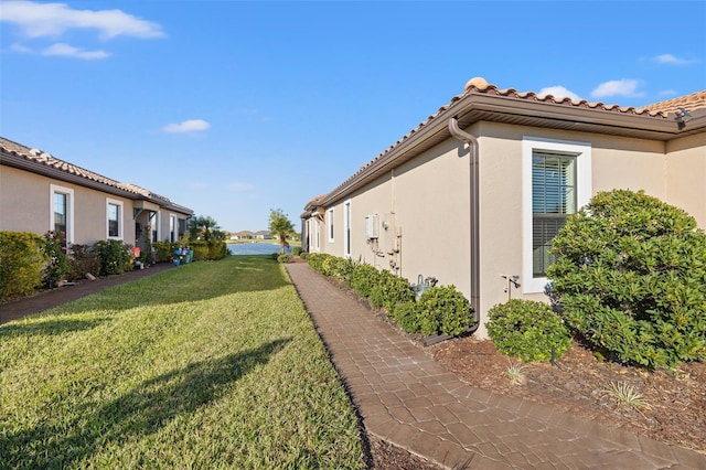 view of side of home featuring a yard