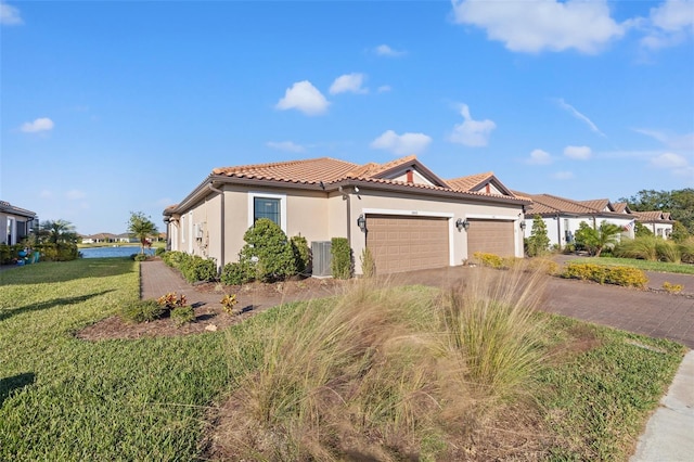 mediterranean / spanish-style house with a front yard and a garage