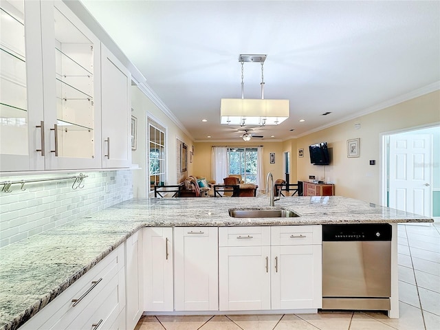 kitchen featuring dishwasher, sink, kitchen peninsula, pendant lighting, and white cabinets