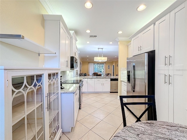 kitchen featuring white cabinetry, stainless steel appliances, kitchen peninsula, crown molding, and light tile patterned floors