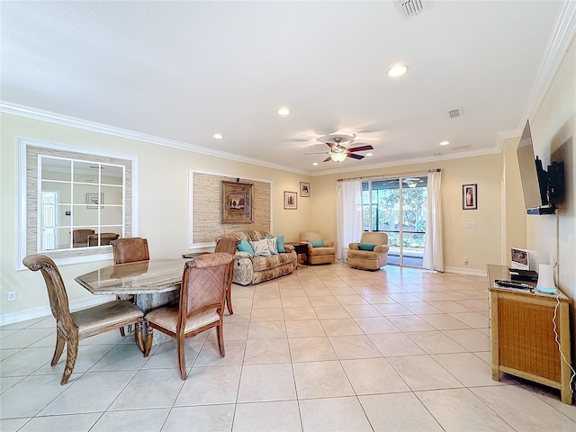 dining room featuring ceiling fan, light tile patterned floors, and crown molding