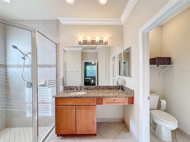 bathroom featuring vanity, toilet, an enclosed shower, and crown molding