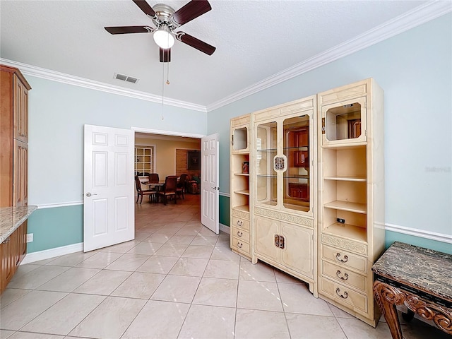 interior space with a textured ceiling, ceiling fan, and crown molding