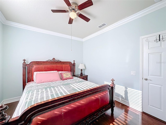 bedroom featuring ceiling fan, crown molding, and dark wood-type flooring