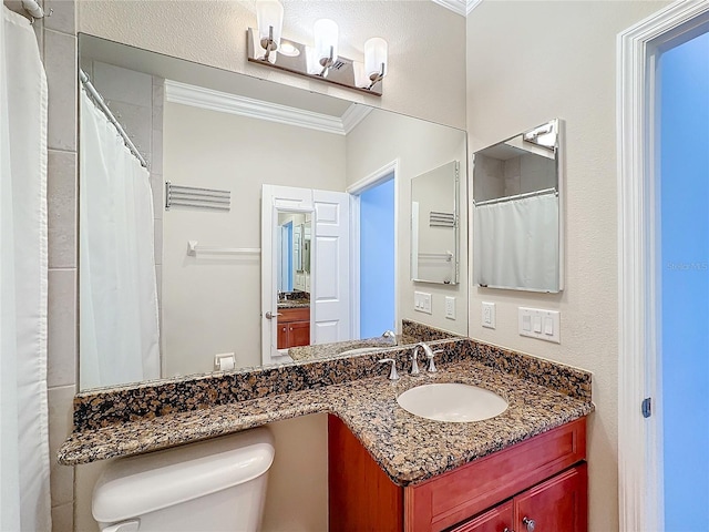 bathroom featuring vanity, toilet, and crown molding