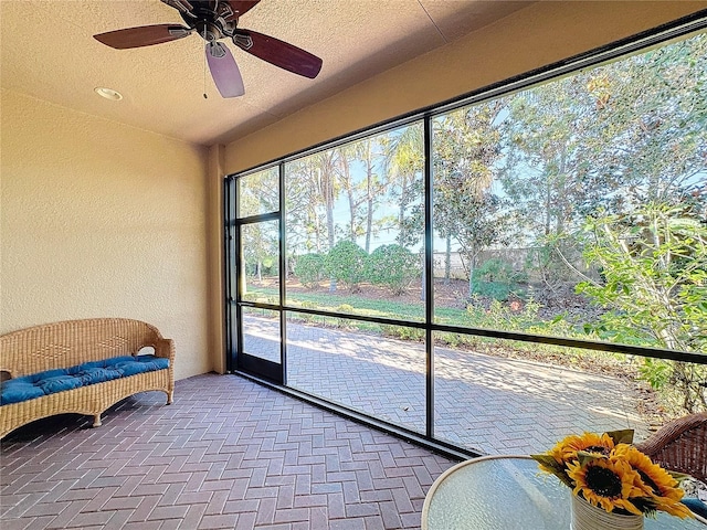 sunroom featuring ceiling fan