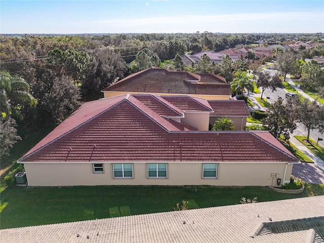 exterior space featuring cooling unit and a yard