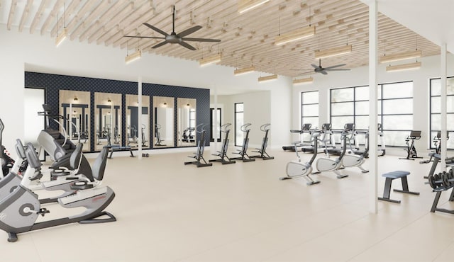 exercise room with wooden ceiling, ceiling fan, and a high ceiling