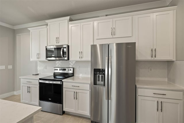 kitchen featuring white cabinetry, decorative backsplash, ornamental molding, and appliances with stainless steel finishes