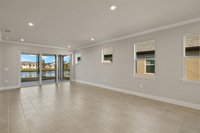 tiled spare room featuring ornamental molding and a water view