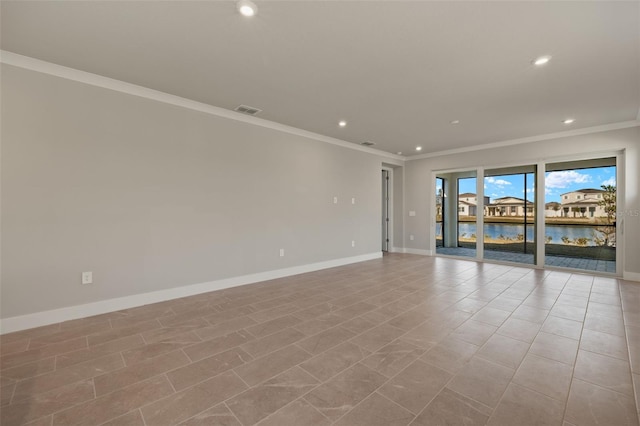 empty room with ornamental molding and a water view