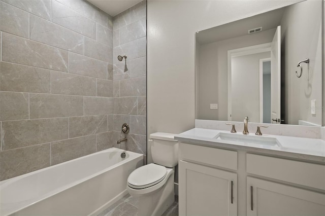 full bathroom featuring tiled shower / bath, vanity, and toilet