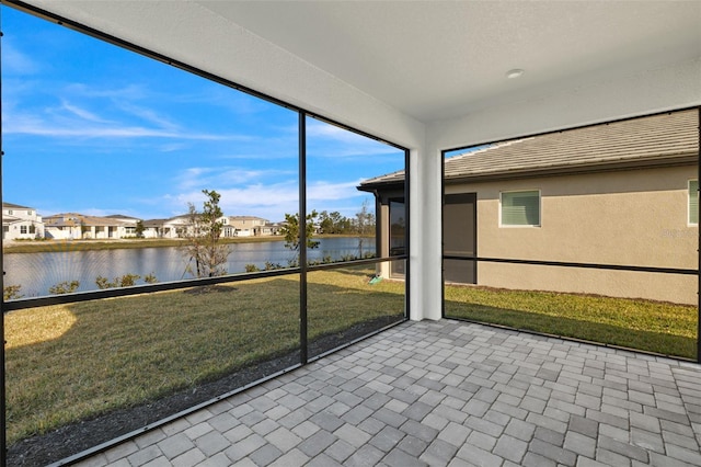 unfurnished sunroom with a water view