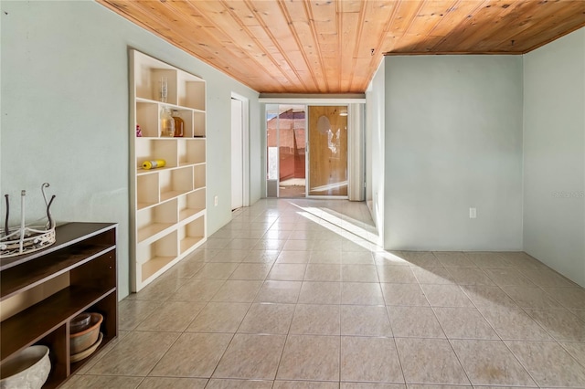 hallway featuring light tile patterned floors and wood ceiling