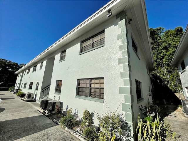 view of side of property with cooling unit and a patio