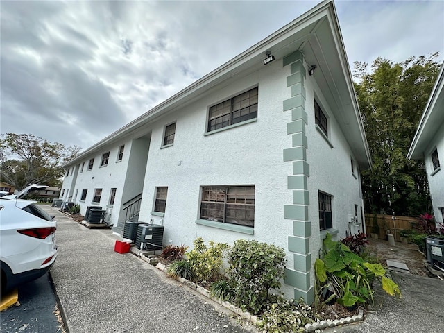 view of side of home with central AC