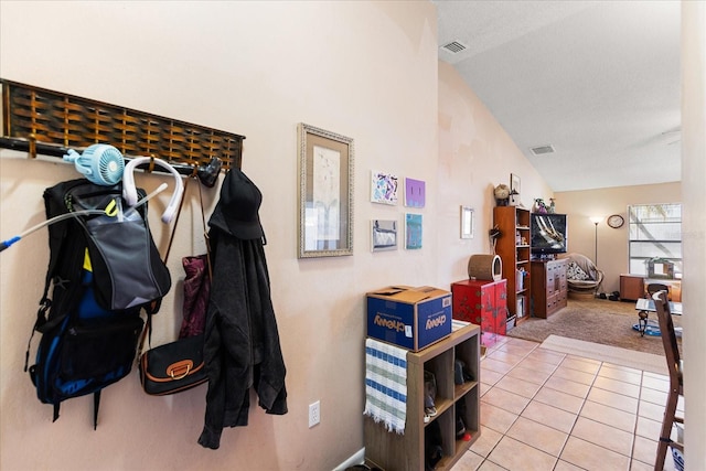 interior space with high vaulted ceiling and tile patterned floors