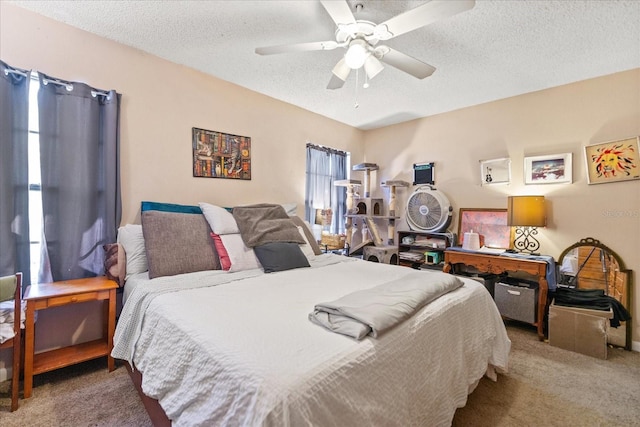 carpeted bedroom with ceiling fan and a textured ceiling