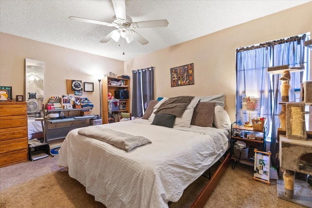 bedroom featuring carpet flooring, ceiling fan, and a textured ceiling