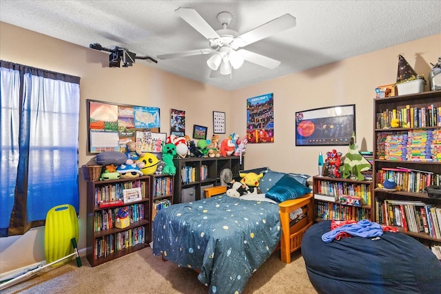 carpeted bedroom featuring ceiling fan and a textured ceiling