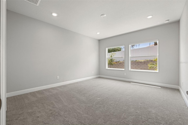 empty room with visible vents, baseboards, carpet flooring, and recessed lighting