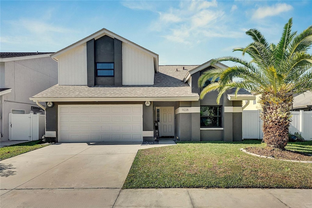 view of front facade with a front yard and a garage