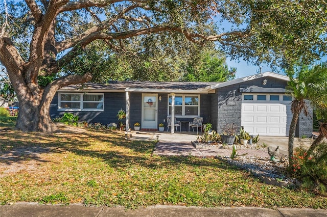 single story home featuring a patio area, a front lawn, and a garage