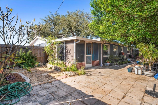 exterior space with a sunroom and a patio