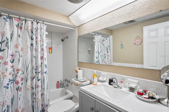 full bathroom featuring vanity, tasteful backsplash, toilet, and shower / bath combo with shower curtain