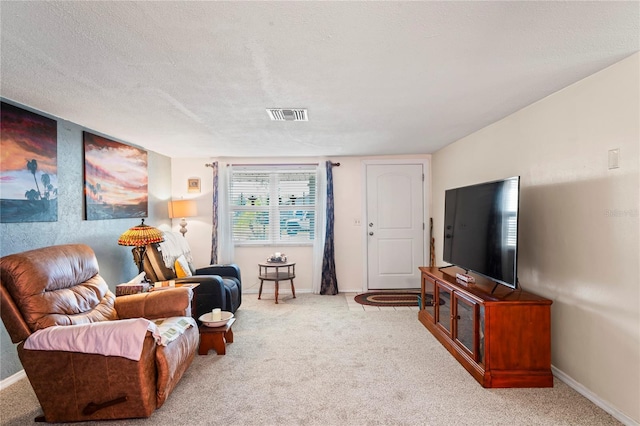 carpeted living room featuring a textured ceiling