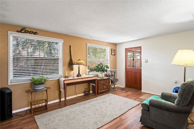 sitting room with dark hardwood / wood-style flooring and a textured ceiling