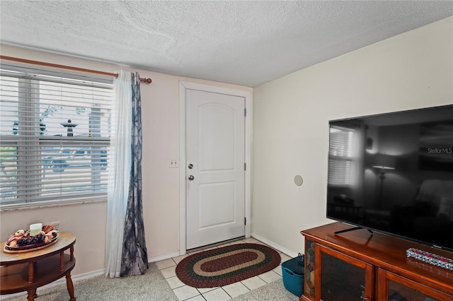 tiled foyer with a textured ceiling