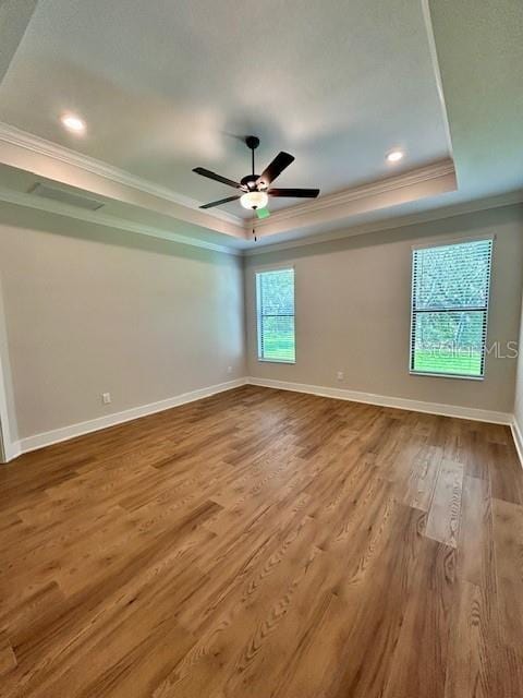 13400 Haflinger Way, Hudson, FL 34667 - unfurnished room featuring a tray ceiling, crown molding, wood finished floors, recessed lighting, and a ceiling fan