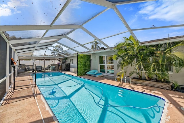 view of pool featuring a lanai and a patio