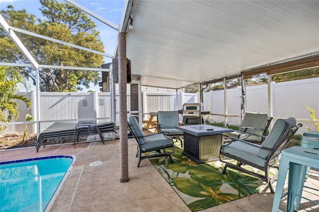 view of patio / terrace with a fenced in pool, a lanai, and an outdoor fire pit