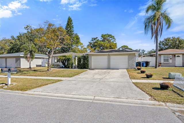 single story home featuring a garage and a front yard