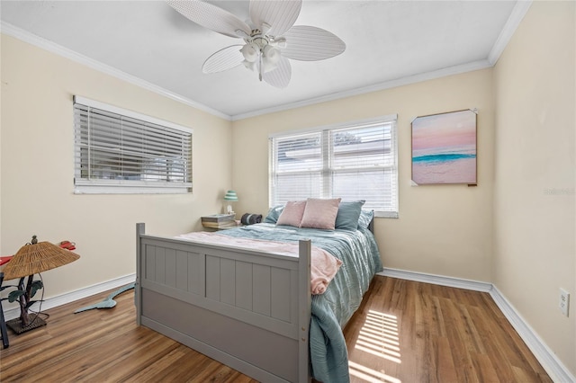 bedroom featuring wood-type flooring, ceiling fan, and crown molding