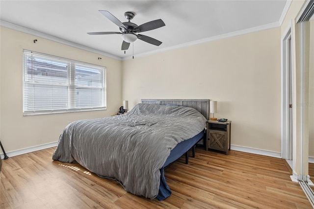 bedroom featuring light wood-type flooring, ceiling fan, and crown molding