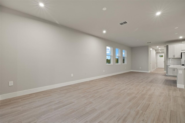 unfurnished living room with light wood-type flooring