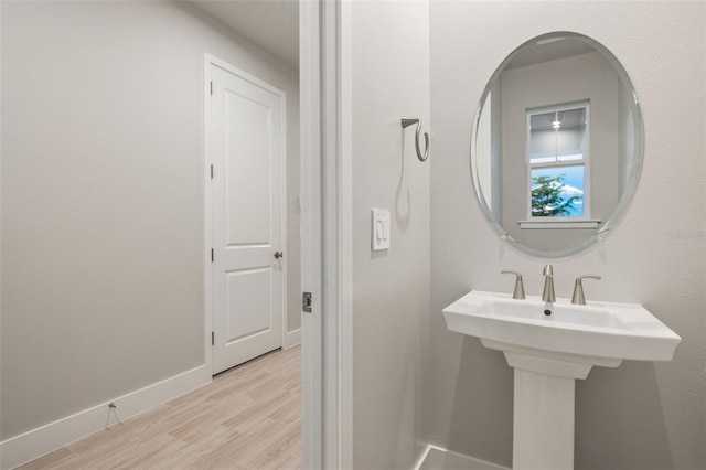 bathroom with hardwood / wood-style flooring