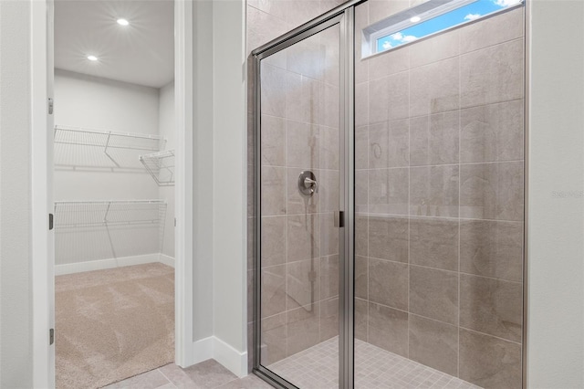 bathroom featuring a shower with shower door