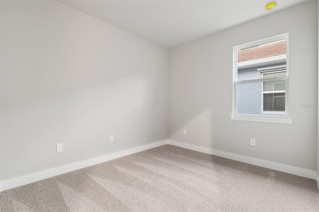 spare room featuring carpet floors and a wealth of natural light