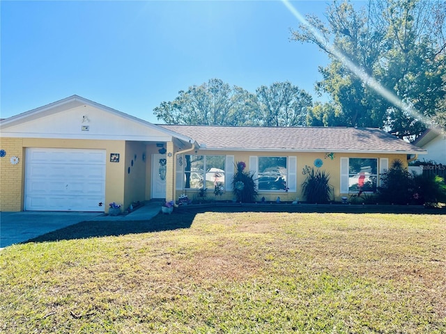 single story home featuring a garage and a front lawn