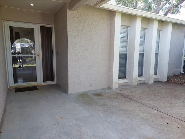 entrance to property featuring a patio