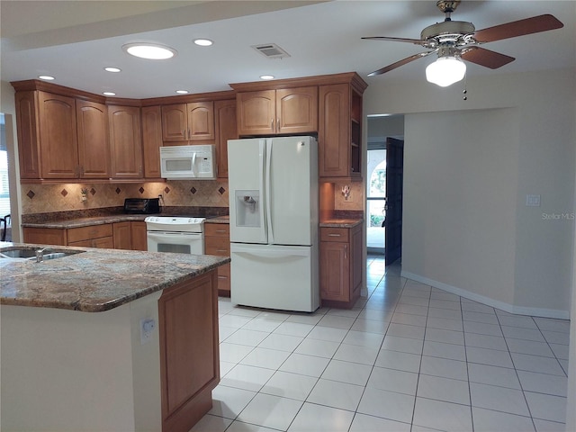 kitchen featuring ceiling fan, sink, light tile patterned floors, and white appliances