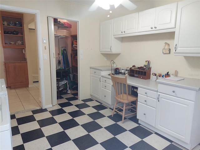 office space featuring built in desk, washer / clothes dryer, and ceiling fan