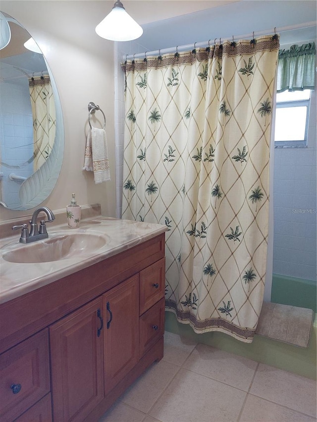 bathroom featuring vanity, tile patterned floors, and curtained shower