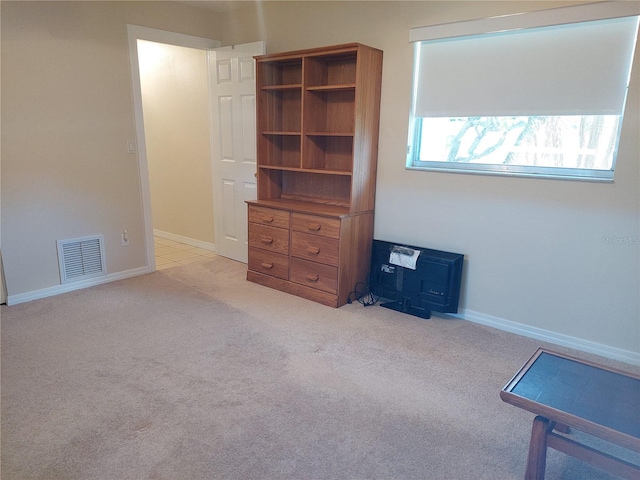 unfurnished bedroom featuring light carpet