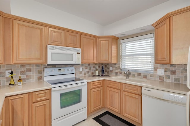 kitchen with light brown cabinetry, white appliances, backsplash, and sink