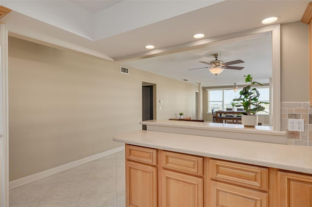 kitchen featuring tasteful backsplash, ceiling fan, light brown cabinets, and light tile patterned floors